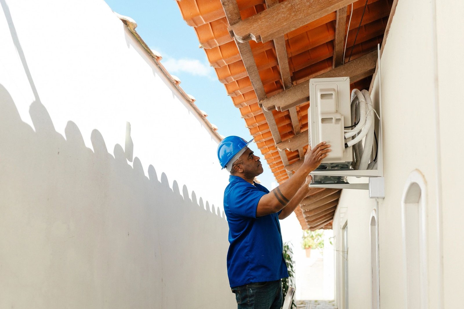 HVAC technician checking an outdoor air conditioning unit